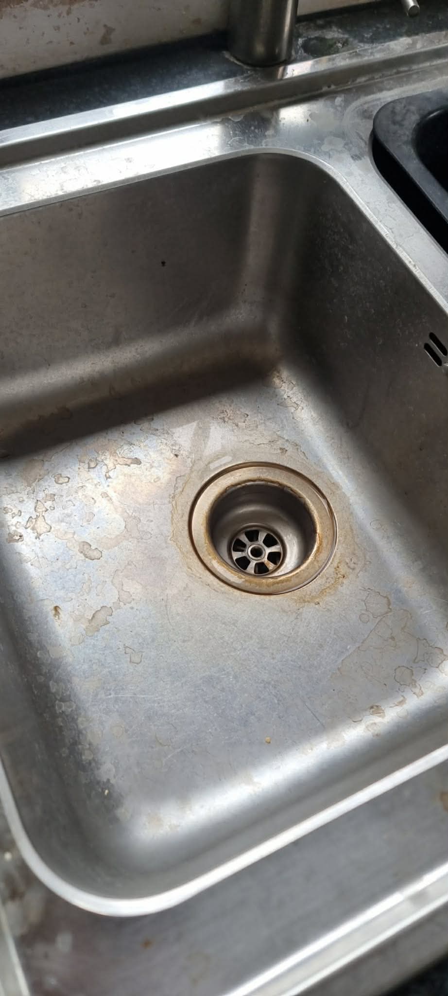 Stainless-steel kitchen sink before cleaning